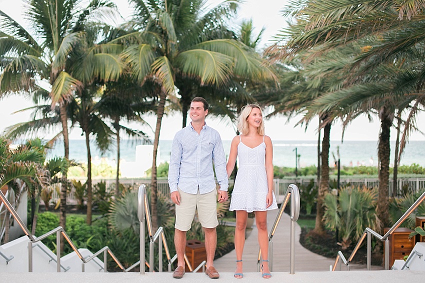 engaged couple holding hands on south beach