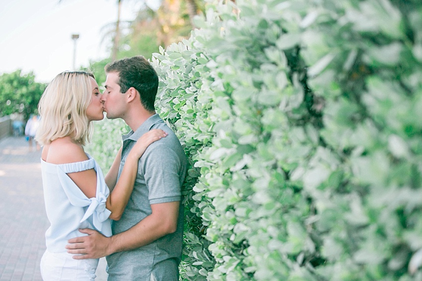 Engaged couple kissing on south beach.